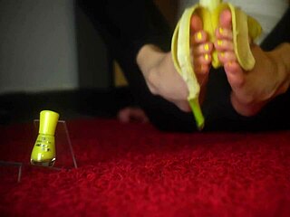 Jelisa Rose's feet playing with a banana in a yellow submarine setting