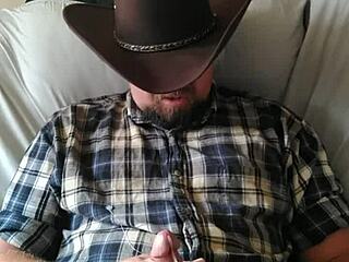 Cowboy strokes his cock to orgasm, building up a massive load