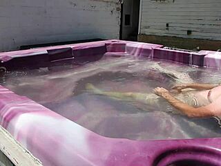 dayanara relaxing in the hot tub with a shaved look
