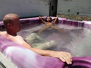 dayanara relaxing in the hot tub with a shaved look