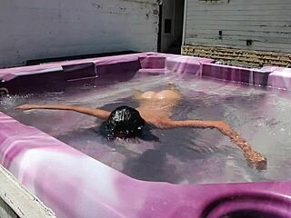 dayanara relaxing in the hot tub with a shaved look