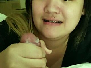 Asian girlfriend giving a blowjob to her boyfriend