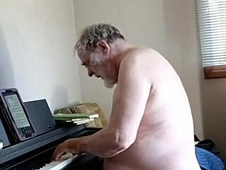 Naked pianist Daniel Roy Bloomquist performs on the piano