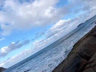 Detailed blowjob scene with big tits in voyeur setting on rocks