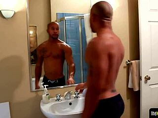 Ebony gay strokes his hard cock with tattoos