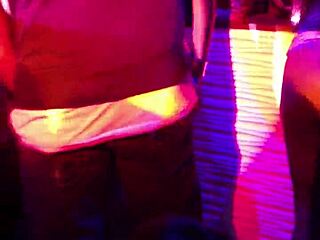 girl subtly sits on ciroc bottle while pleasuring another on stage