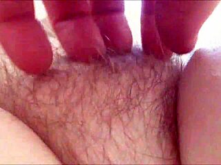 Amateur milf rubs her hairy pussy at home