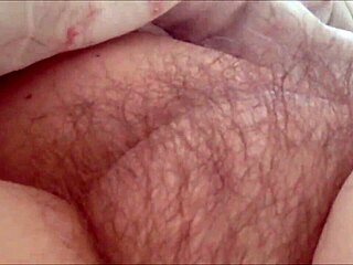 Aroused mature woman masturbates her furry intimate area
