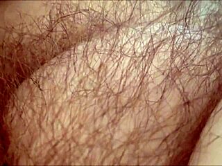 Amateur milf rubs her hairy pussy at home
