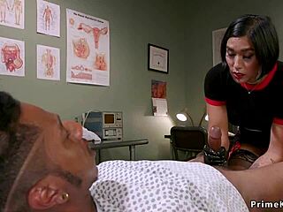 Busty Asian Domme Torments Bound Black Guy with Strapon