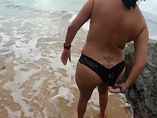 is this milf fucking her partner on the public beach?