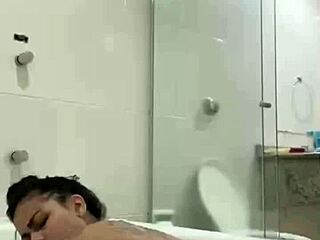 i'm bia hot brunette relaxing with the shower jet in the bath