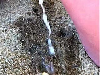 My wife peeing long on the beach in wild display