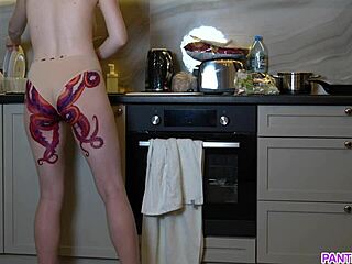 Naked housewife with octopus tattoo on ass cooks in kitchen nude  