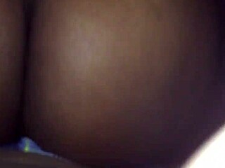 Ebony lesbian boldly rides strap in reverse cowgirl position