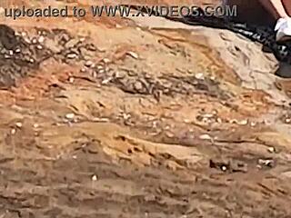 Public beach stone encounter for young Brazilian gay couple