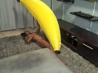 A tattooed Indian woman masturbates and has an orgasm while rubbing her body on a banana