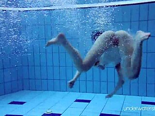 Hot redhead Roxalana goes swimming in the sea and shows her body