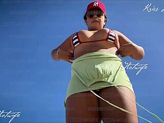 Tanned African beauty in micro bikini makes pussy jump on beach POV.