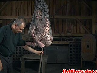 Bound submissive suspended by maledom master in rough bdsm session