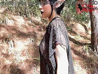 Gothic elf teen masturbating solo with tattoos in a mysterious forest setting.