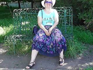 Public showing off: Mature hairy nymph in transparent dress