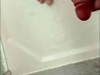 I'm showering my hard cock in the bathroom, feeling the water cascade over my muscular bodybuilder frame with blue eyes.