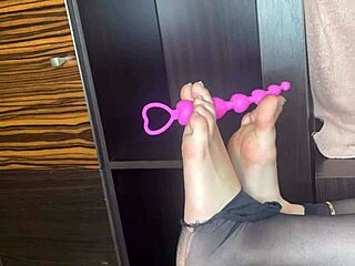 Enjoy a close-up of feet in black stockings using toys on the homemade bed.