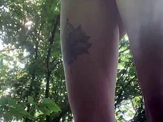 Peeing through bikini pants in public outdoor scene.