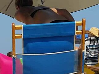 Hidden candid video of a young woman in bikini on the beach