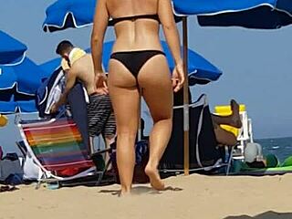 Hidden candid video of a young woman in bikini on the beach