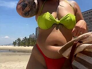 african wife flashing on beach with tight bikini