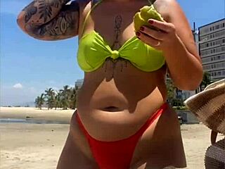 african wife flashing on beach with tight bikini