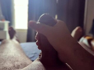 I'm stroking my big cock solo in the bedroom with sun rays filtering through the window.