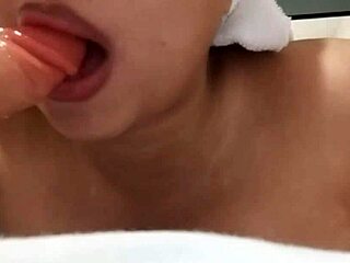 Chubby busty beauty sucks dildo