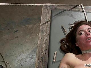 Busty babe bent over gets ass caned in bondage