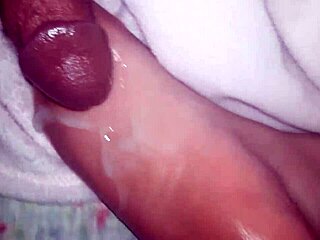 cumshot lands on oiled feet in casual scene