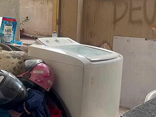 The neighbor watches secretly as the woman washes clothes with her pussy and tits exposed