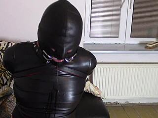 Katja the crossdresser gets tied up in leather bondage and drools uncontrollably