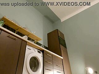 Young brunette babe strips panties under skirt in kitchen