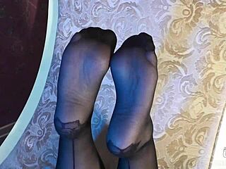 Sexy goddess in black pantyhose with rose print on heels teases you with her feet and toes