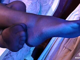 Sexy goddess in black pantyhose with rose print on heels teases you with her feet and toes