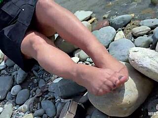 Goddess In Tan Nylons Shows Her Cute Nylon Soles And Toes On The Riverside