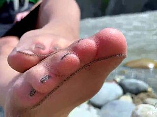 Goddess In Tan Nylons Shows Her Cute Nylon Soles And Toes On The Riverside