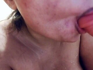 Chubby asian babe with big tits sucks on realistic dildo full of milk in closeup view