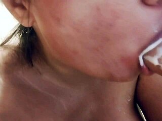 Chubby asian babe with big tits sucks on realistic dildo full of milk in closeup view