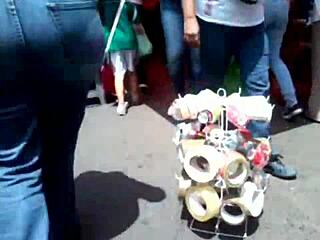 curvy woman in jeans walking down the street in casual outfit