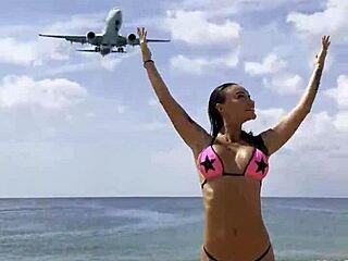 Monika Fox poses solo in pink bikini on beach