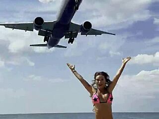 Monika Fox poses solo in pink bikini on beach