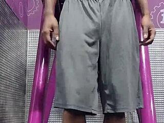 athletic brunette uses machine in dorm workout room